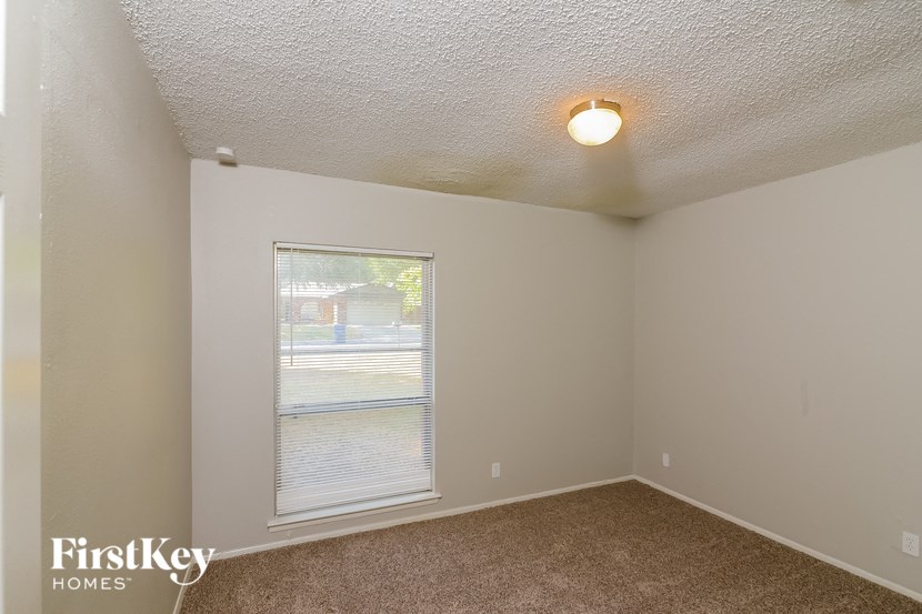 the living room of an empty house with a large window