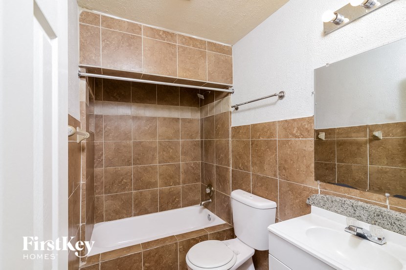 a bathroom with a sink toilet and a bath tub