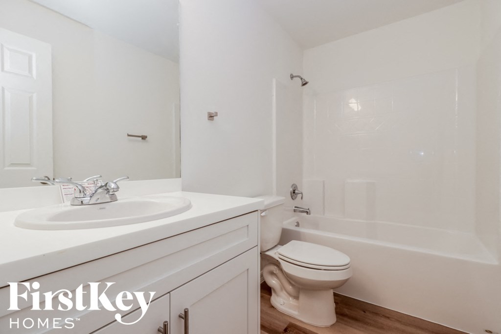 a bathroom with a sink toilet and a bath tub