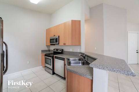 a kitchen with granite counter tops and stainless steel appliances