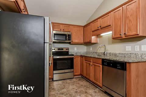 full kitchen with stainless steel appliances and granite counter tops