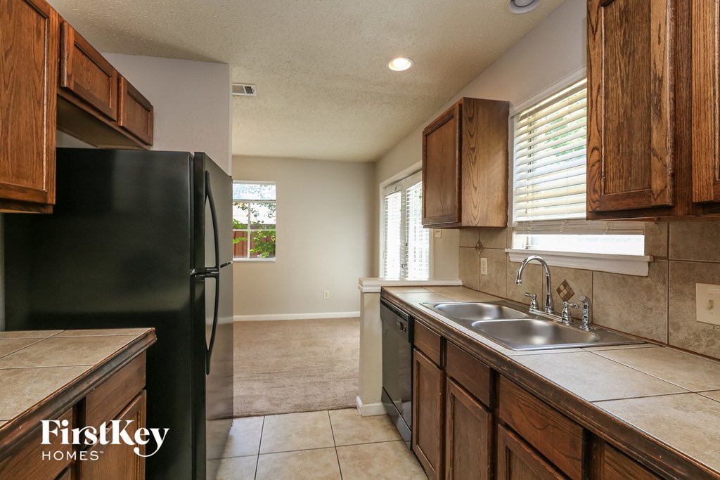 a kitchen with a sink and a refrigerator