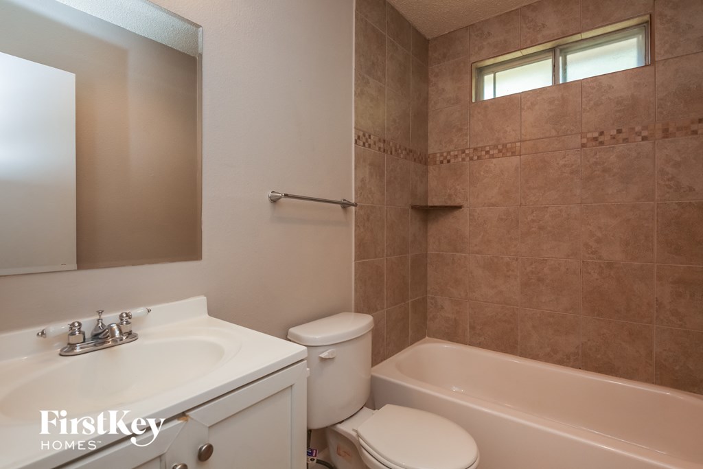a bathroom with a sink toilet and a tub