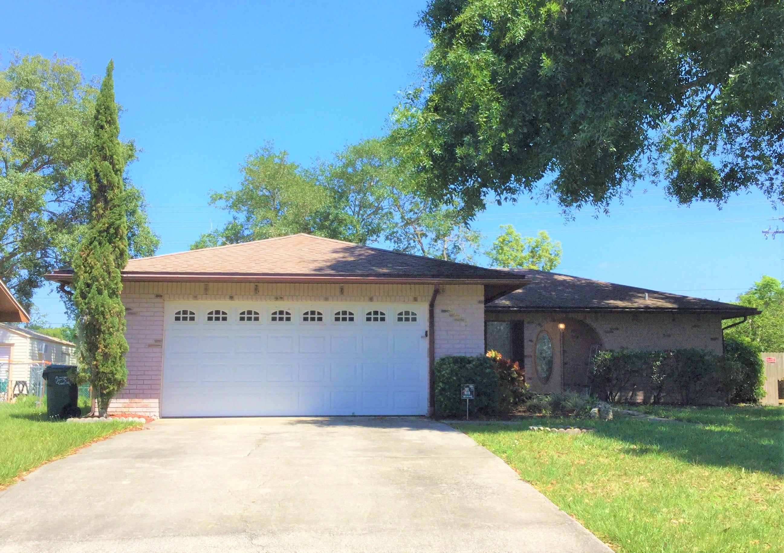 a house with a white garage door and a driveway