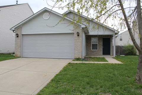 a white house with a sidewalk in front of it