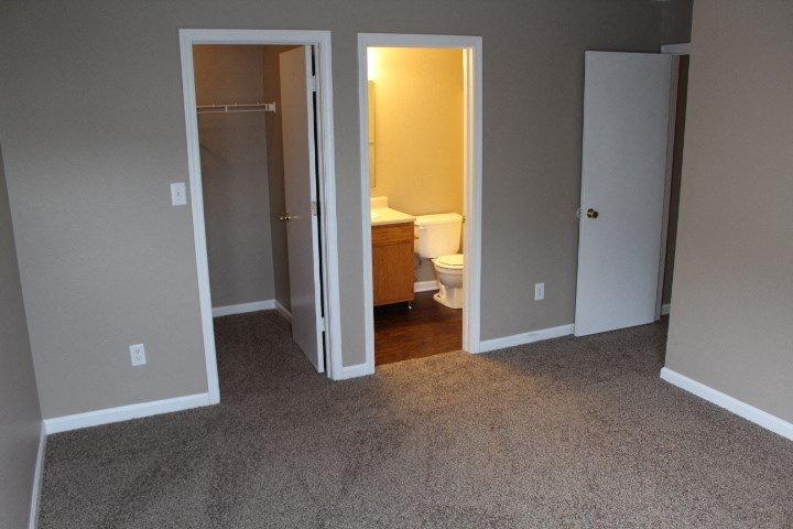 a bathroom with a toilet and a closet