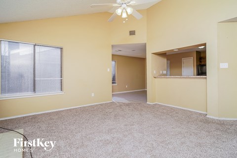 A spacious room with a fan and a window.