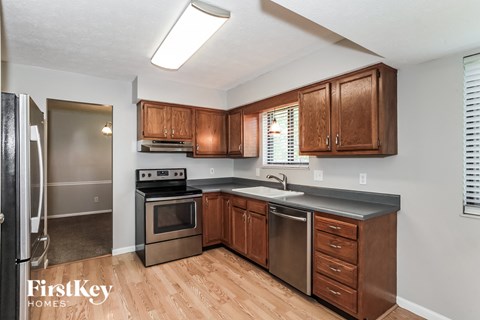 A kitchen with wooden cabinets and stainless steel appliances.