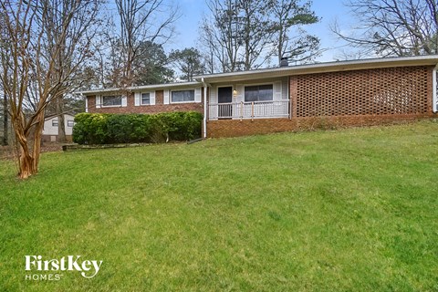 a brick house with a lawn in front of it