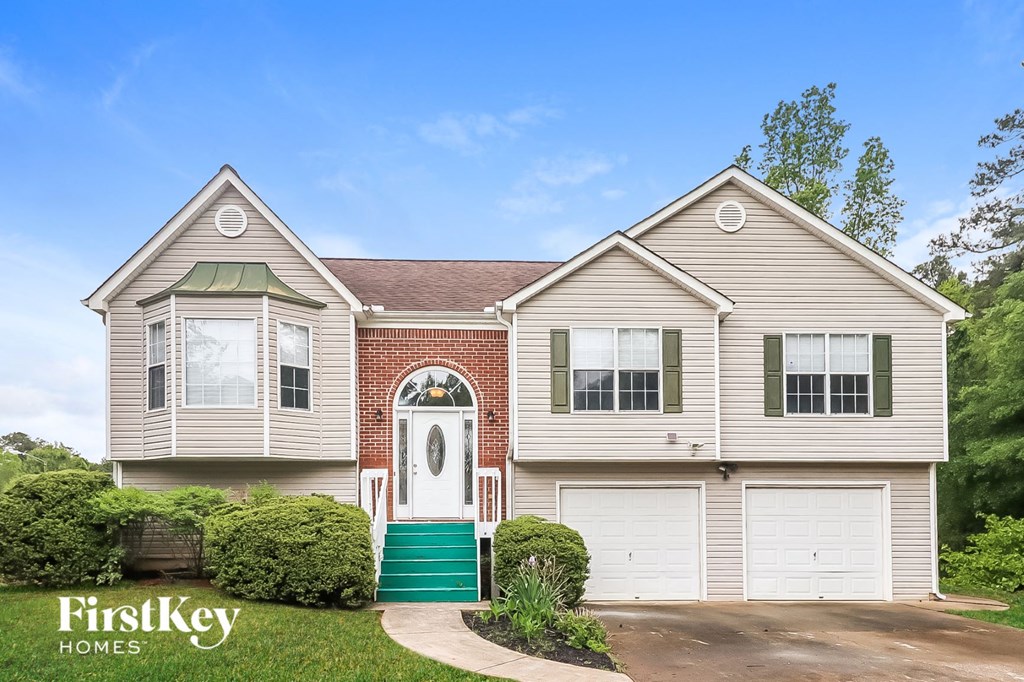 a house with a white door and a green garage door