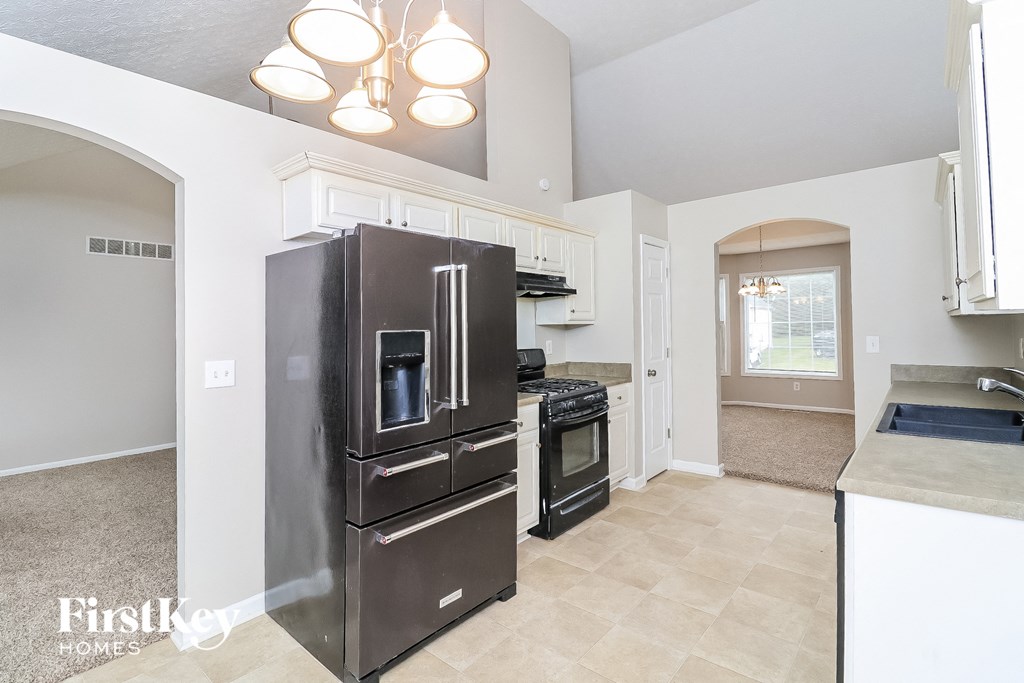 a kitchen with stainless steel appliances and white cabinets