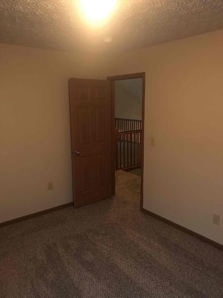 a room with a door and a mirror in it