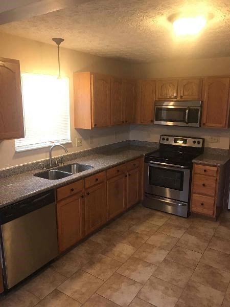 a kitchen with stainless steel appliances and wooden cabinets