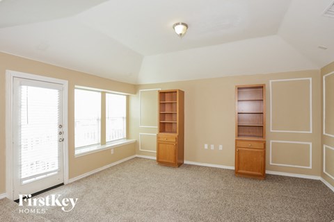a bedroom with a closet and a window and a door