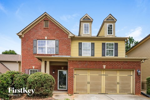 A two-story house with a garage is for sale.