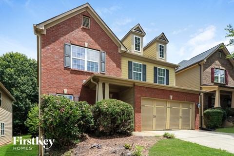 A two-story house with a garage is for sale.