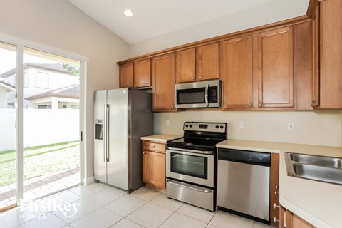 A kitchen with wooden cabinets and stainless steel appliances.