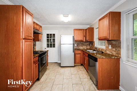 a kitchen with wooden cabinets and stainless steel appliances