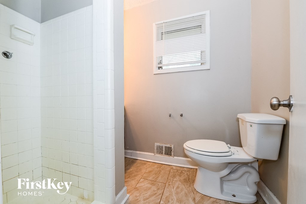 a small bathroom with a toilet and a shower