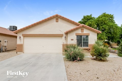 a home with a white garage door and a driveway