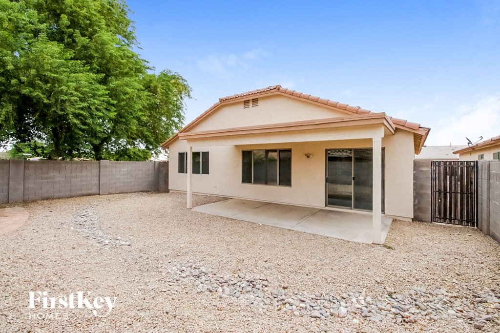 a small house with a yard and a fence
