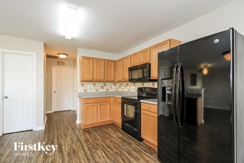 a kitchen with black appliances and wooden cabinets