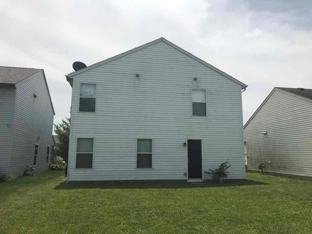 front view of a white house with a grassy yard