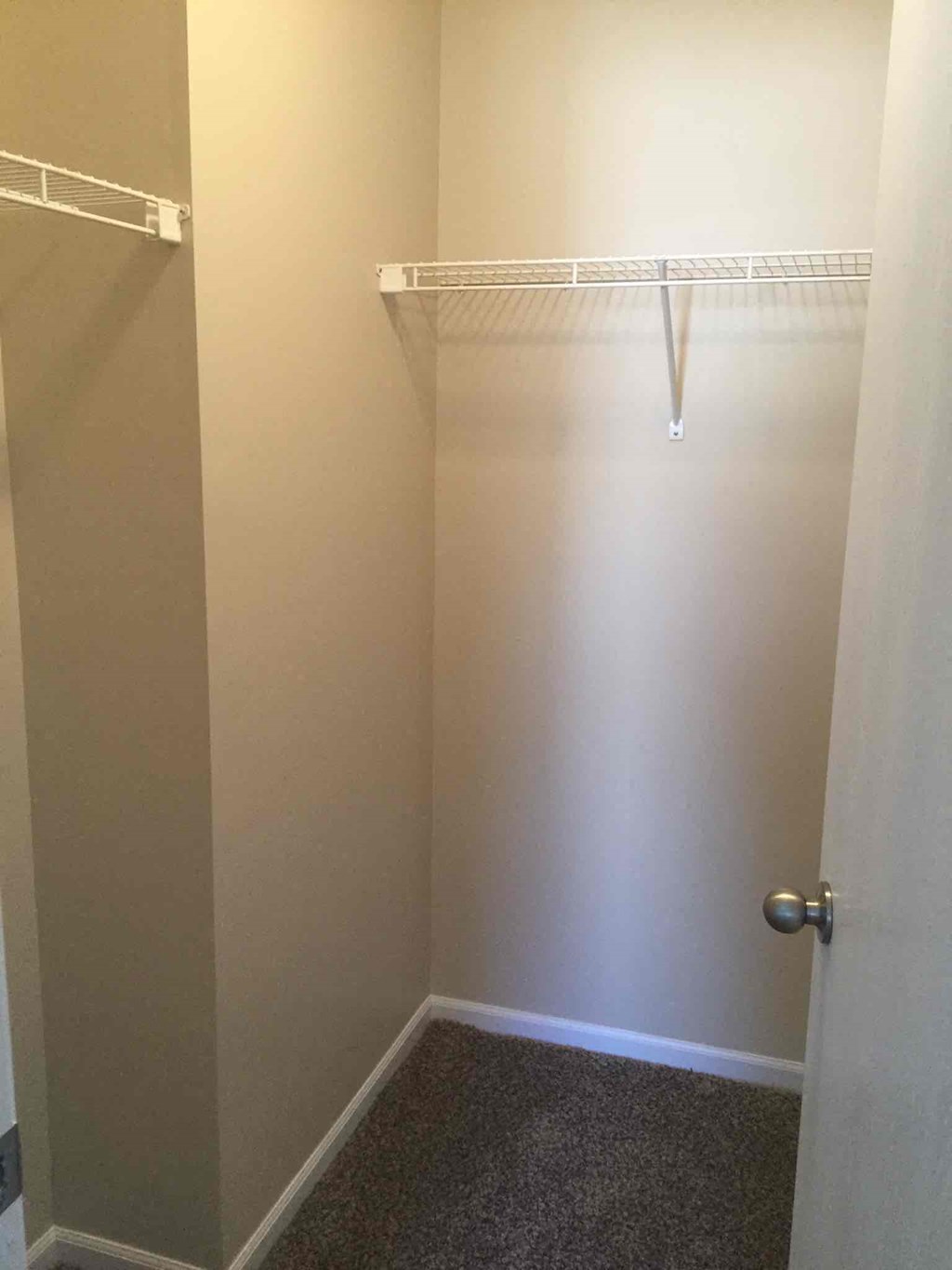 a small bathroom with a walk in closet and a shower