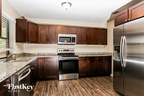 A kitchen with wooden cabinets and stainless steel appliances.
