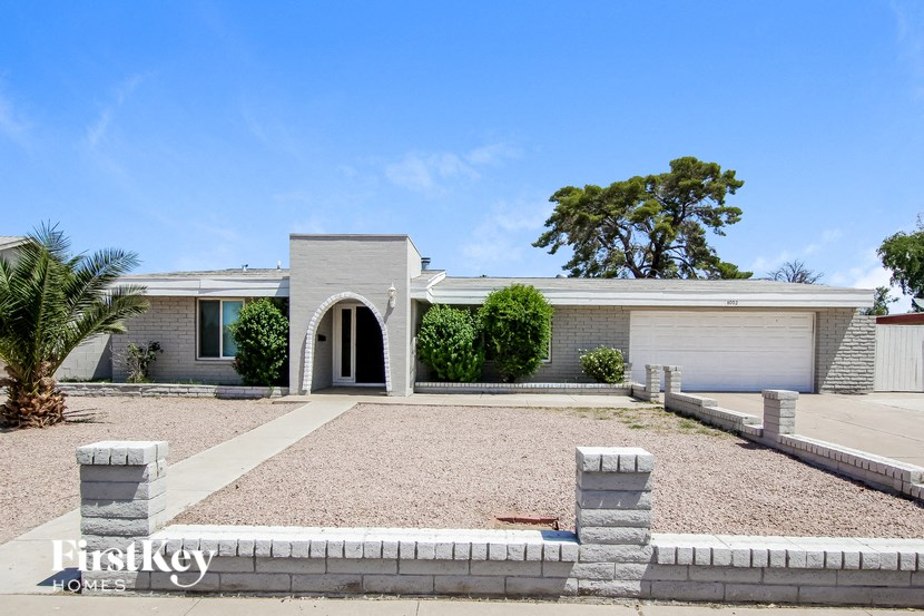 a white house with a driveway and a garage door