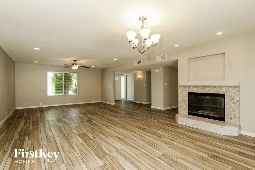 a living room with a fireplace and wooden floors