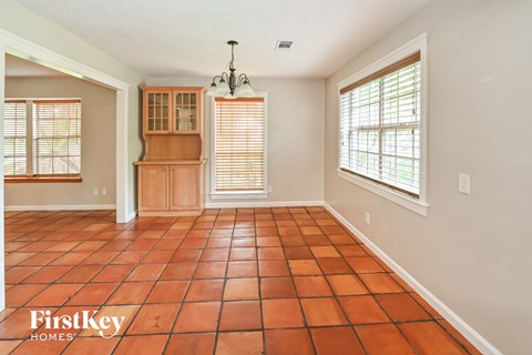 A room with a tile floor and a chandelier.