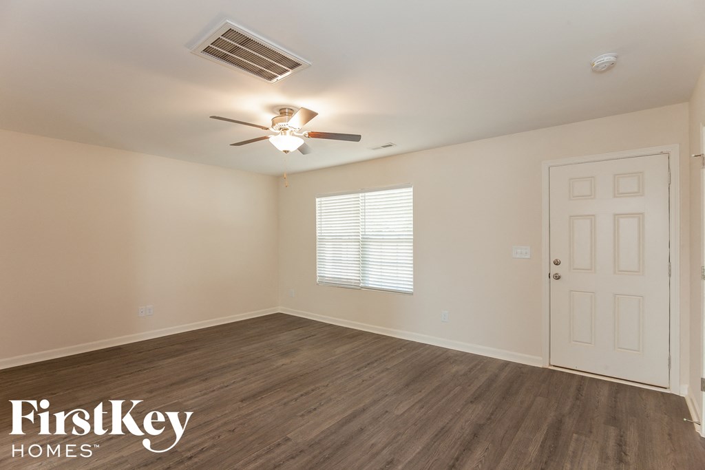a bedroom with a ceiling fan and a white door