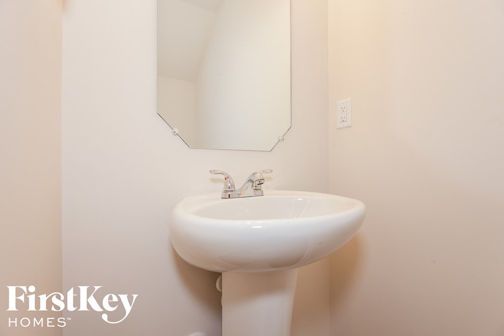 a small bathroom with a sink and a mirror