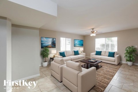 A living room with a couch, a coffee table, and a painting on the wall.