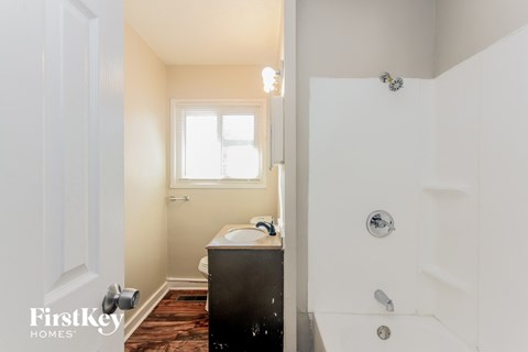 a bathroom with a shower and a sink and a toilet