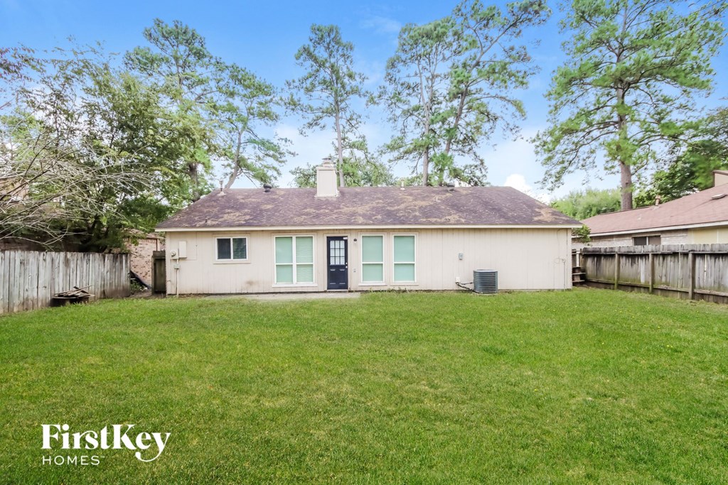 a white house with a yard and a fence