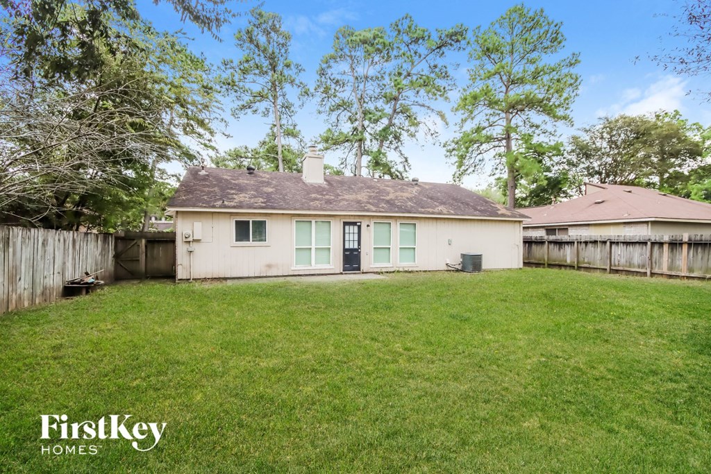 a white house with green shutters and a grass yard
