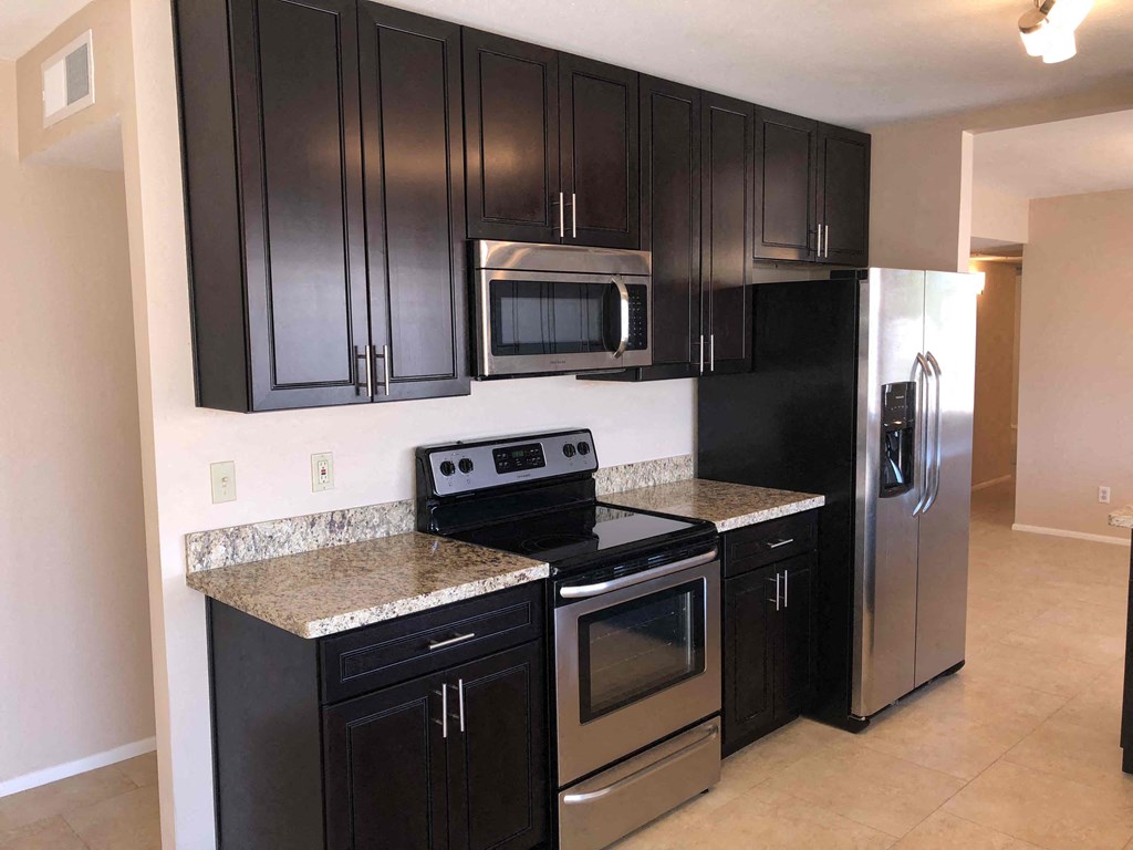 a kitchen with stainless steel appliances and granite counter tops