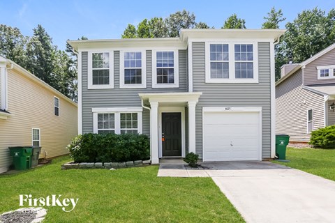 a with a white garage door and a lawn