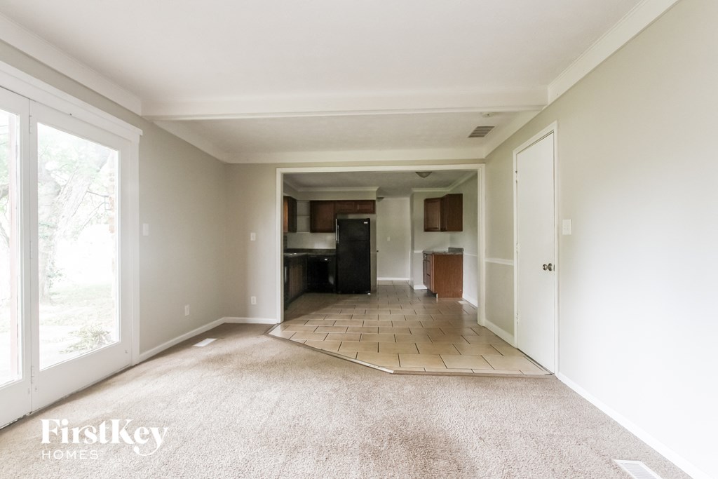 an empty living room and kitchen in a new home