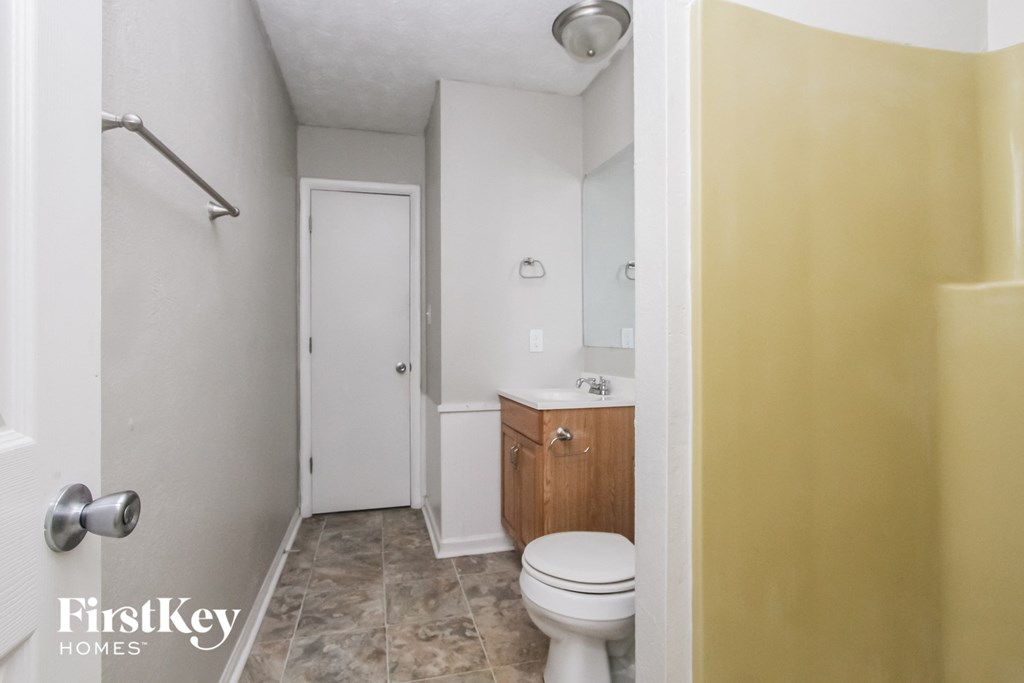 a bathroom with a toilet and a sink and a shower
