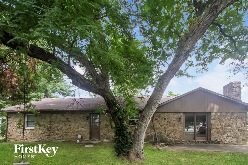 a stone house with a tree in front of it