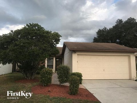 A house with a garage door is for sale.