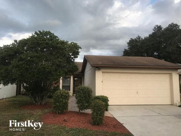 A house with a garage door is for sale.