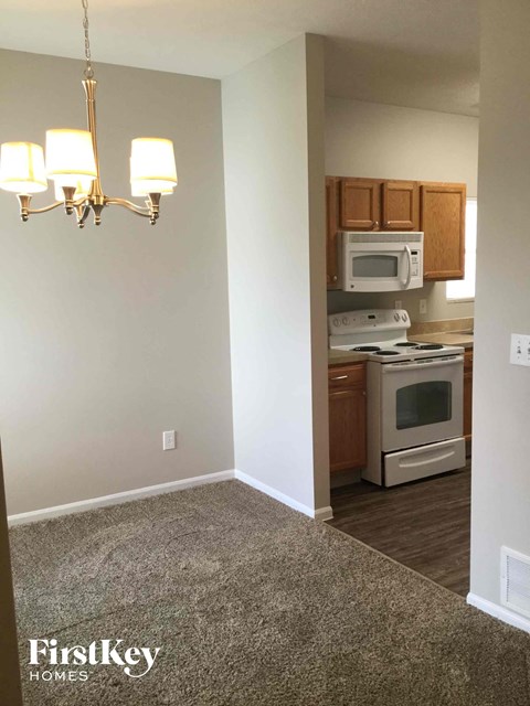 a small kitchen with white appliances and wooden cabinets