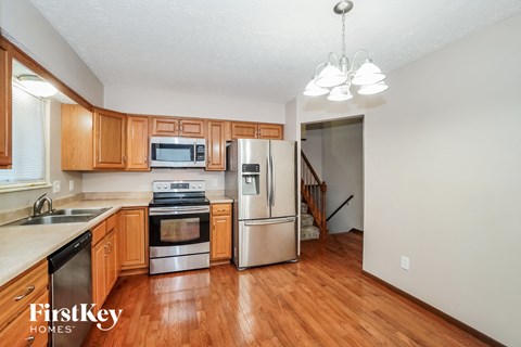 a kitchen with wooden cabinets and stainless steel appliances