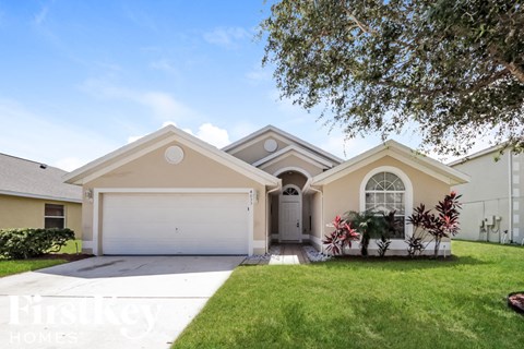 a house with a white garage door and a lawn