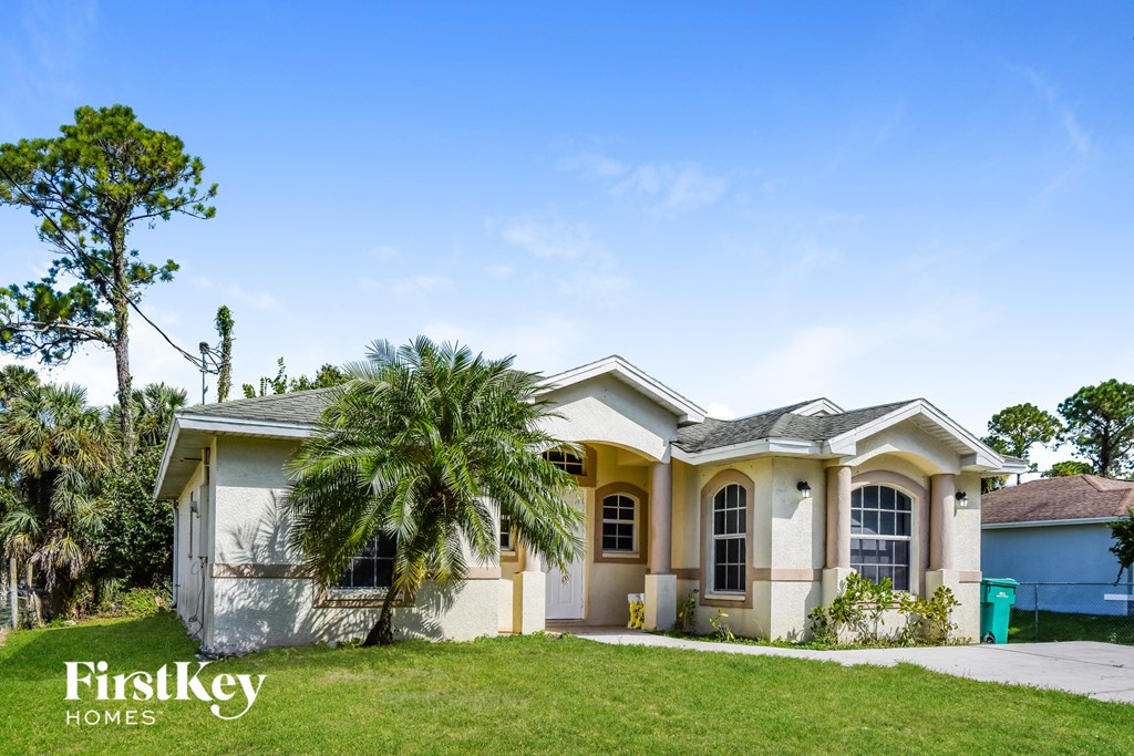 a house with a palm tree in front of it