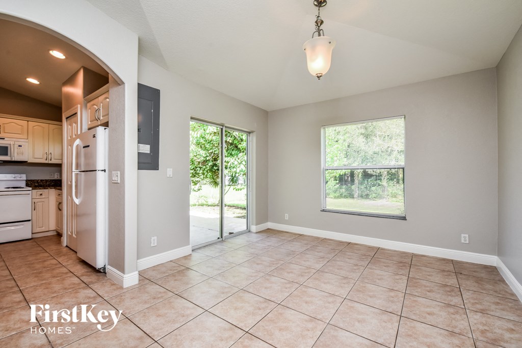 the kitchen and dining room are open to the living room and backyard